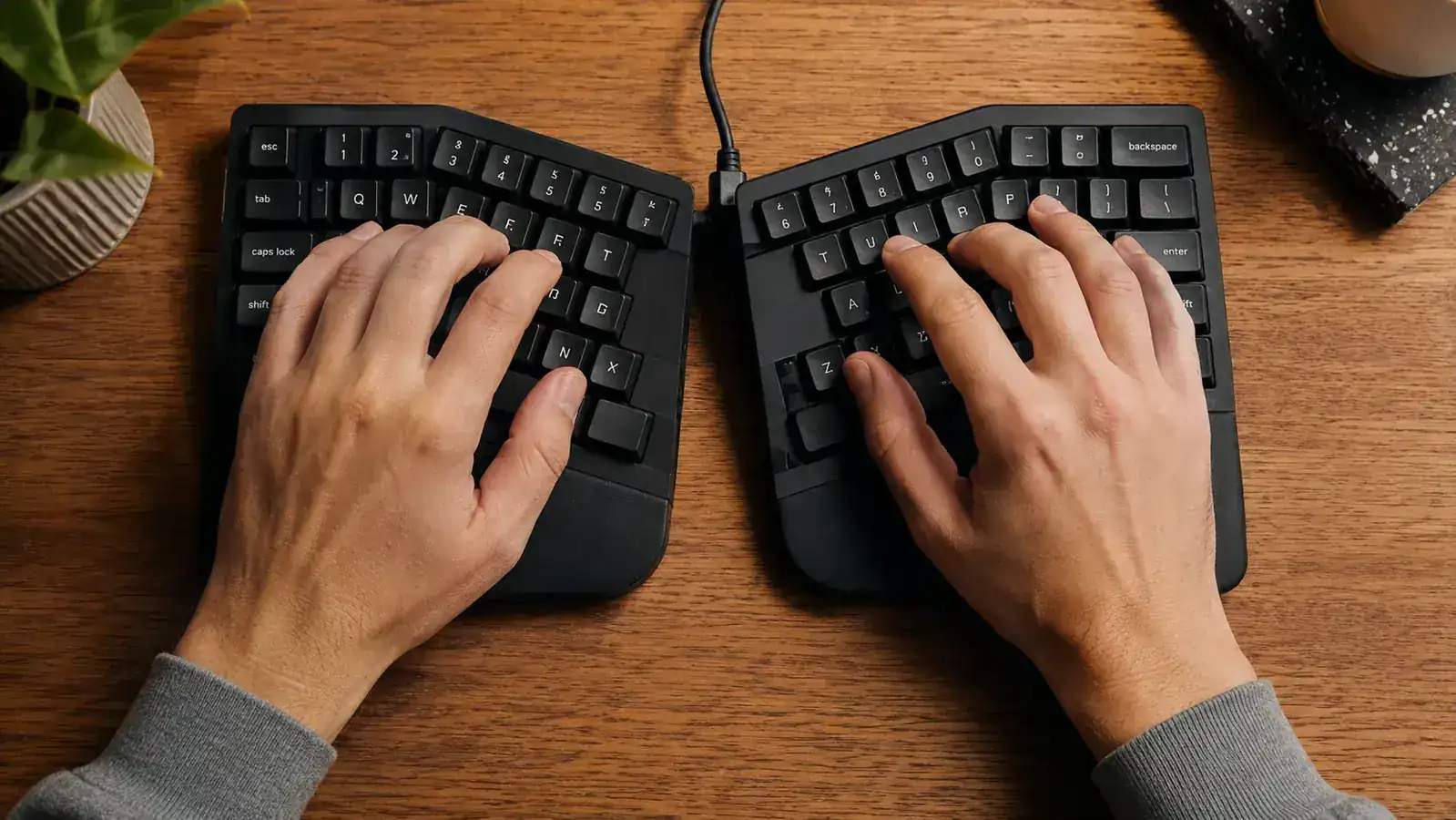 Remote worker typing comfortably at a standing desk using a split ergonomic keyboard