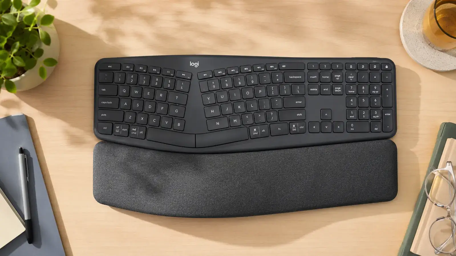 Hands resting on the Logitech K860 wrist rest while typing, showing the natural split angle of the keys