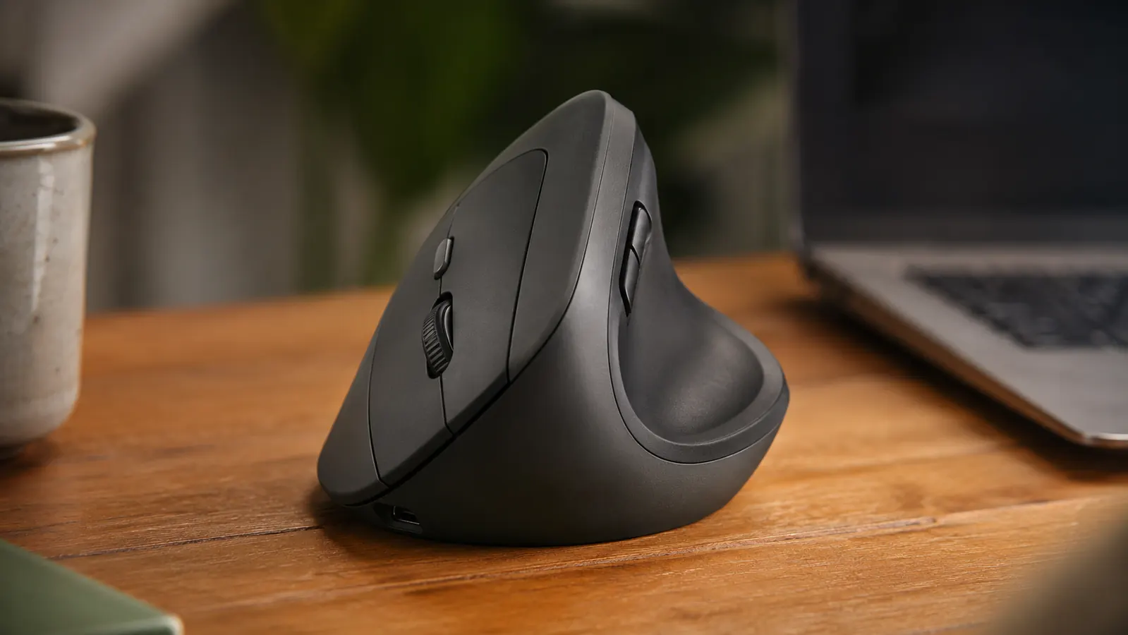 Side profile of the Logitech MX Vertical mouse showing its 57-degree tilt angle with a hand for scale