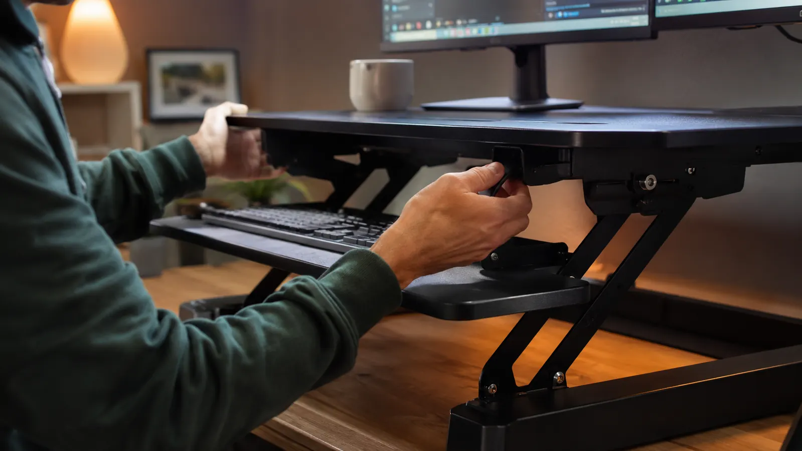 Person standing at a raised VIVO desk converter with correct posture, elbows at 90 degrees, monitor at eye level, anti-fatigue mat visible on the floor below
